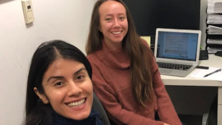 Lab members sitting in front of a computer.