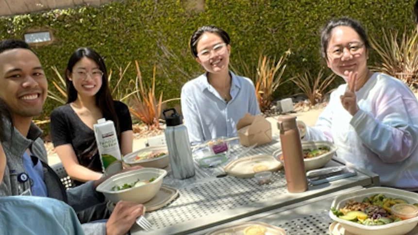 Lee Lab seating outdoors for a casual meal.