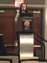 Potemra standing at a podium.